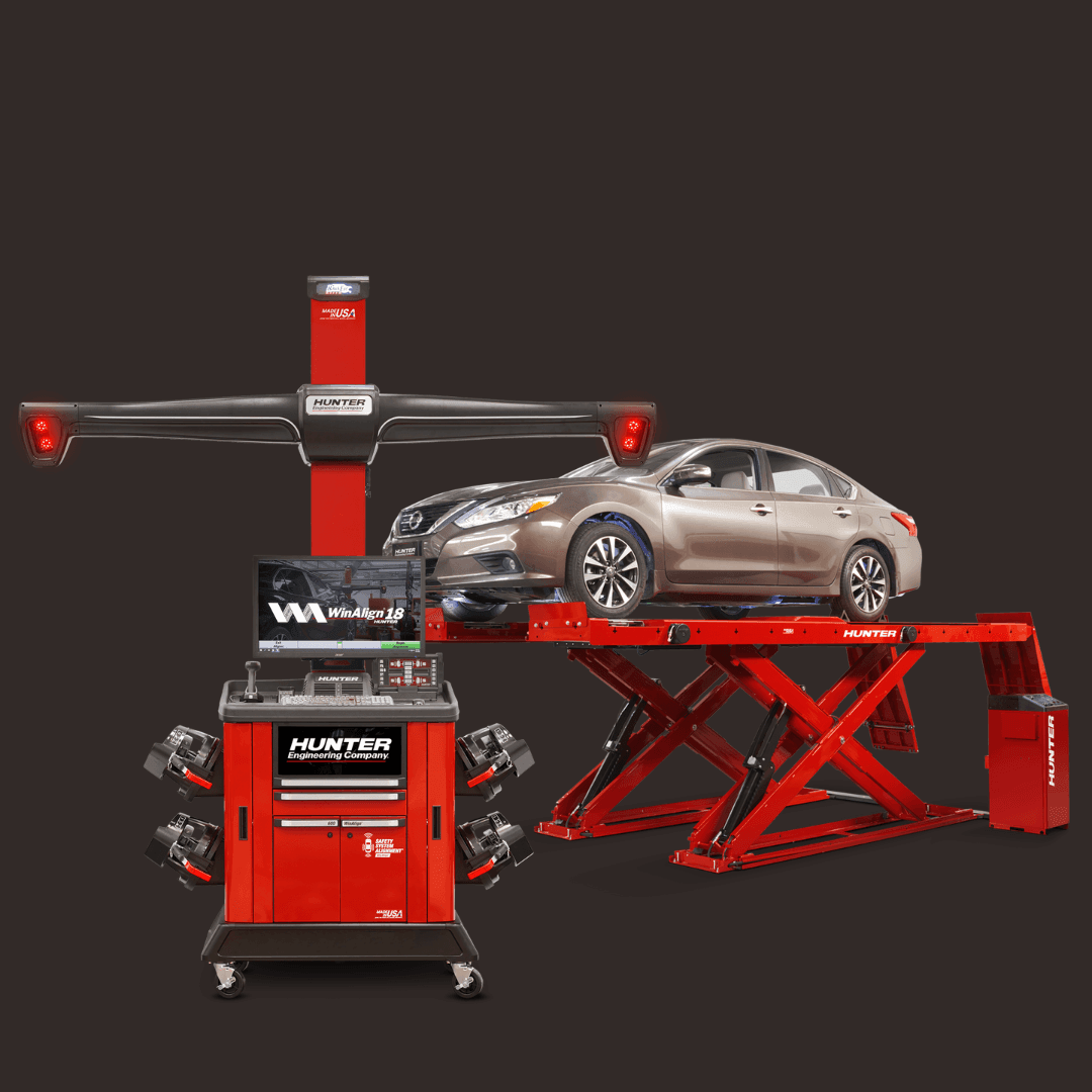 Hunter engineering wheel alignment machine with a car positioned on the red lift and alignment sensors mounted.