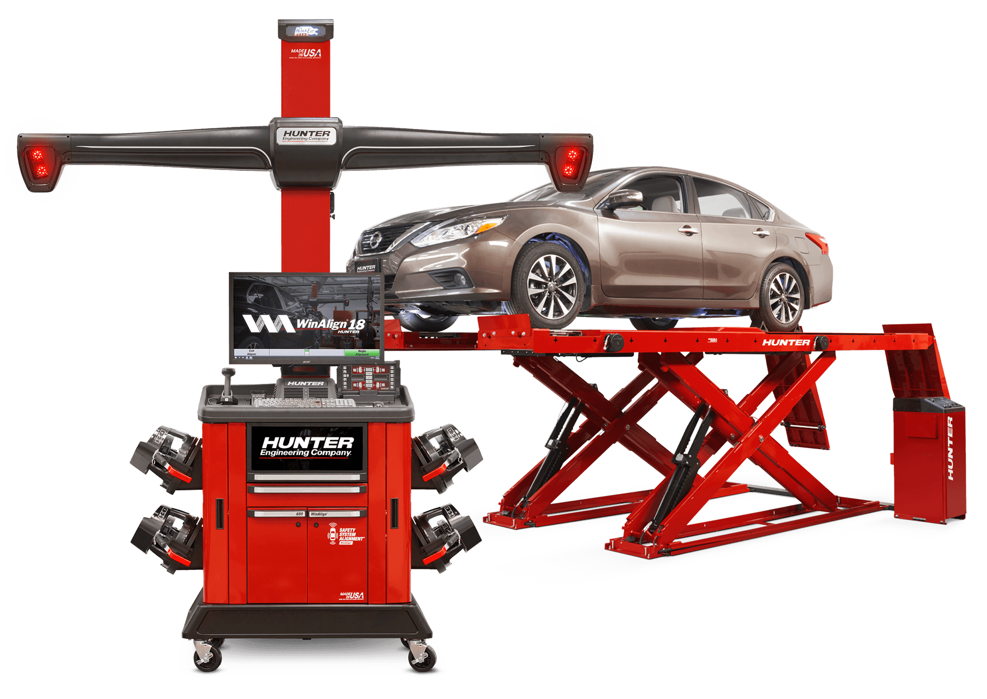 A car on an elevated red platform with a Hunter wheel alignment machine and computer system in front.