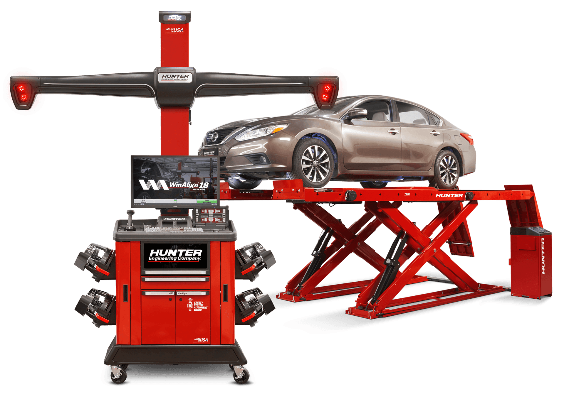 Car on a red vehicle lift with Hunter Engineering wheel alignment system and workstation.