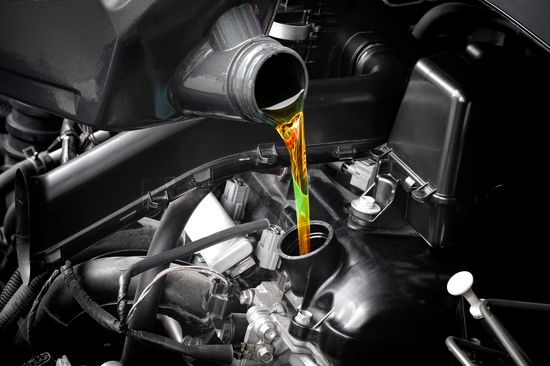 Refueling and pouring oil quality into the engine motor car Transmission and Maintenance Gear.Energy fuel concept.