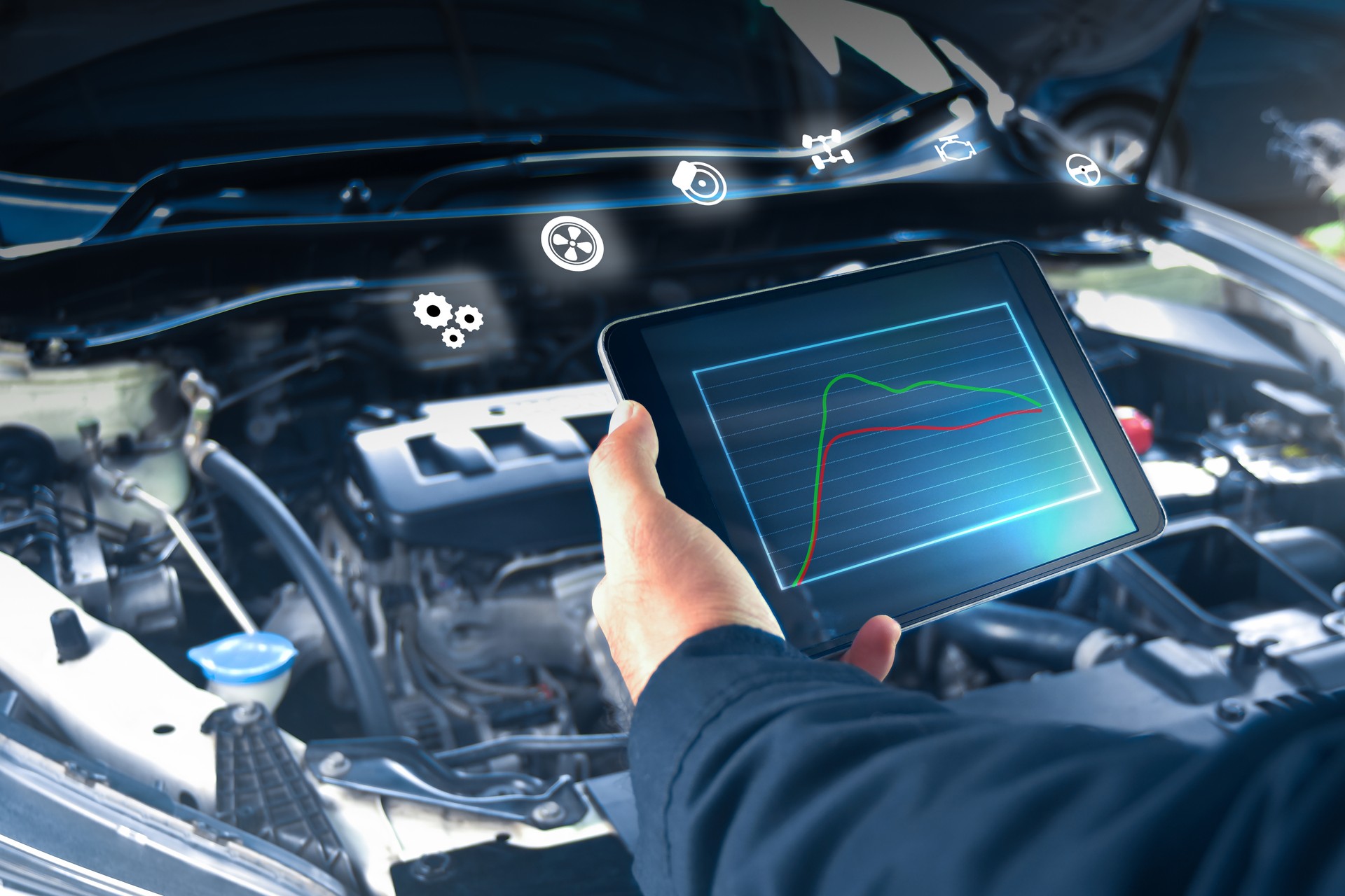 Auto mechanic is checking engine system with a ODB2 tablet and auto service icon